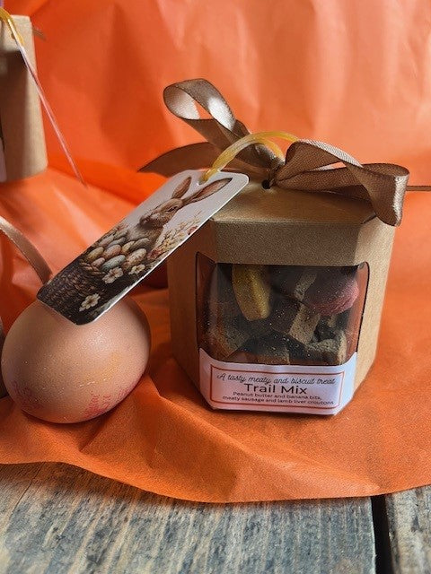 Trail mix packaging with a decorative bow on an orange background